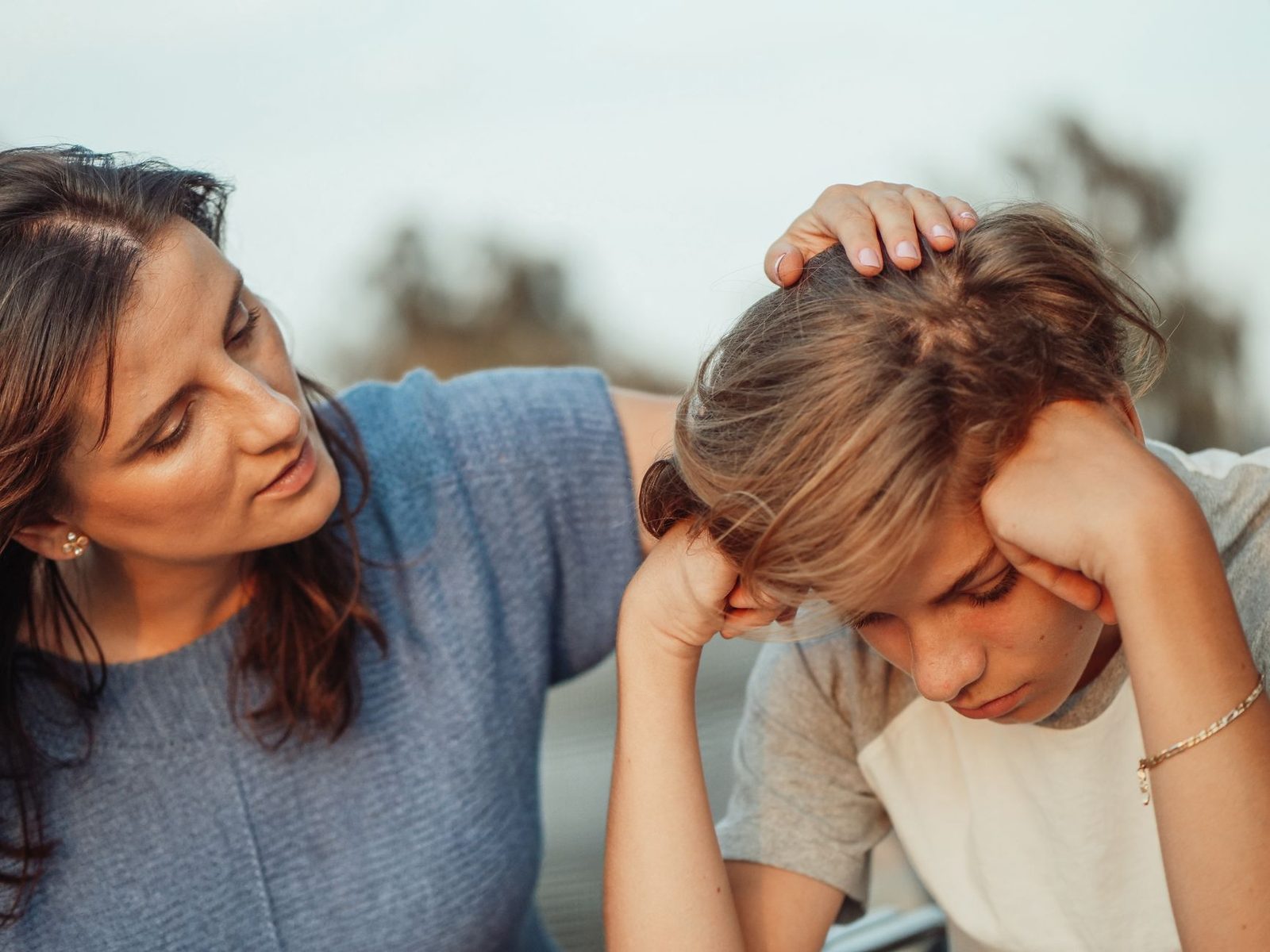 A mother offers quiet, understanding support to her discouraged teenage son.
