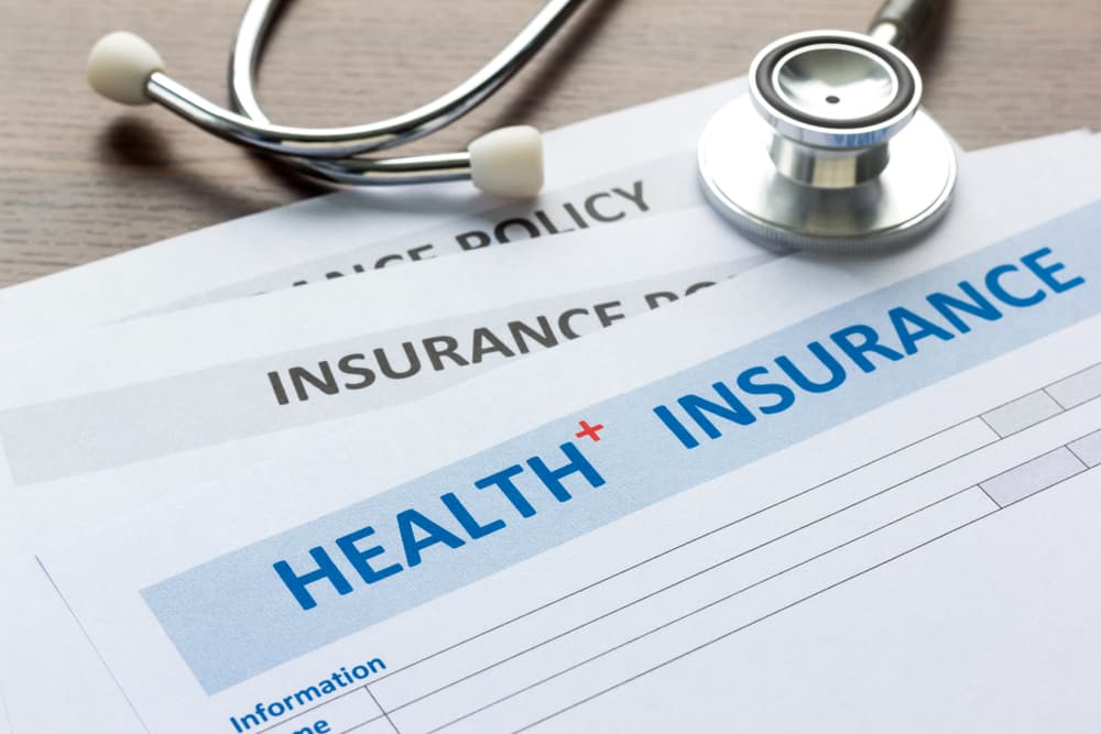 Health insurance form with stethoscope in top view