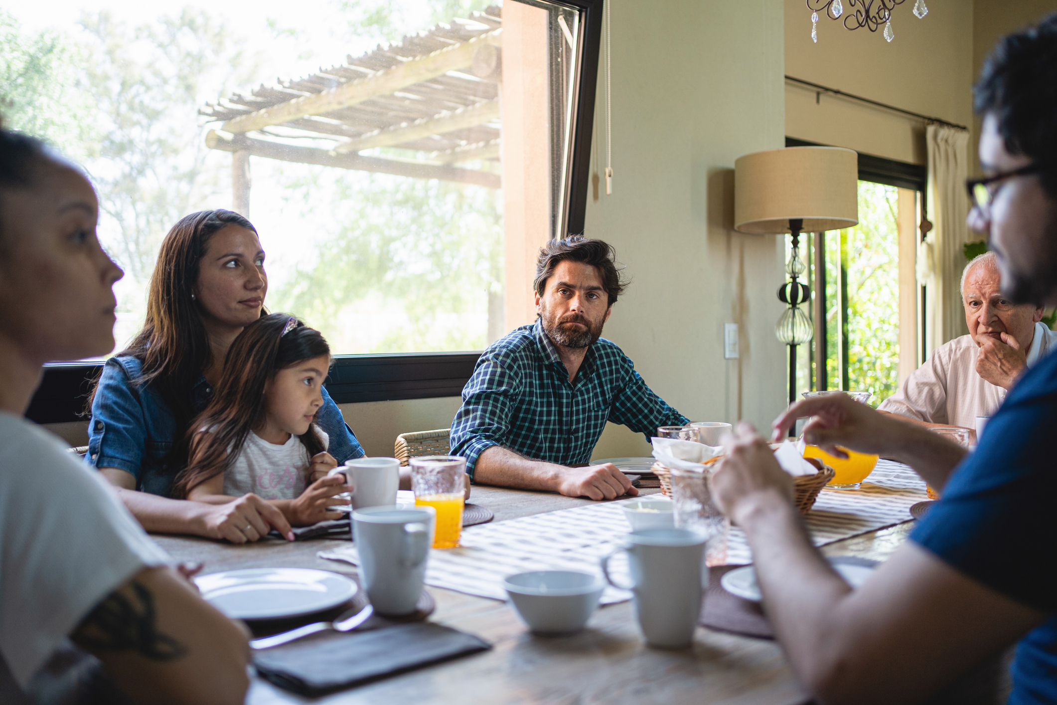 Big family sitting at the dinner table together in the morning