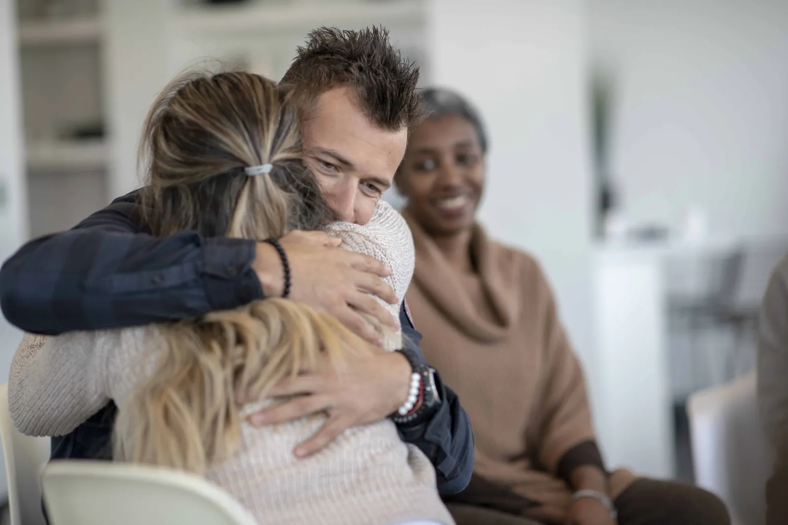 man hugging woman